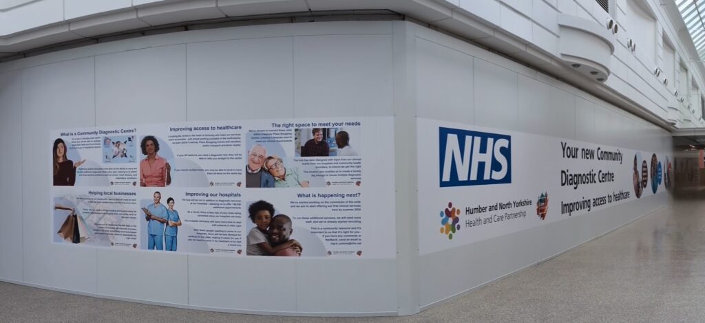 The exterior hoarding of the site, on Baxtergate, Freshney Place