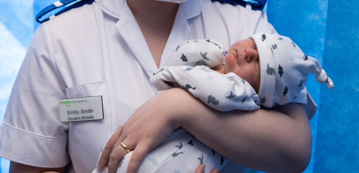 Student midwife Emily Smith holds a newborn at Scunthorpe General