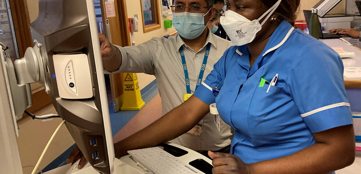 Staff using electronic prescribing and medicines administration system on a ward