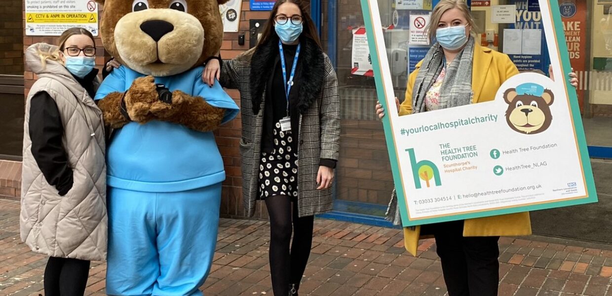 Staff from the Health Tree Foundation pictured with Scrubs the bear