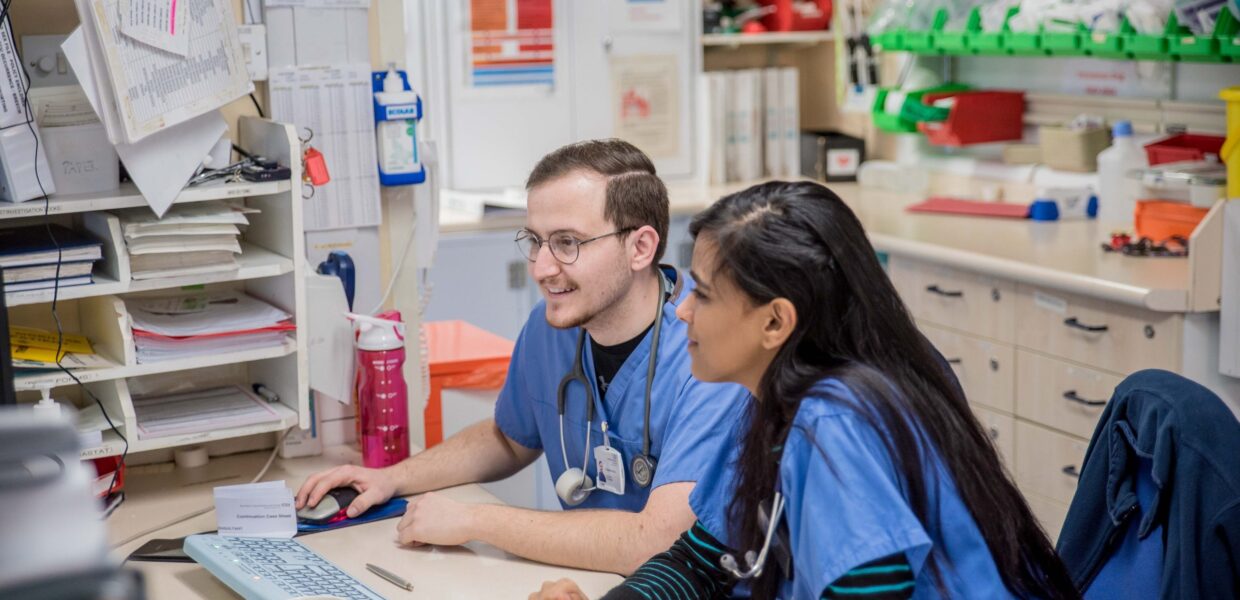 two doctors sat working at a computer